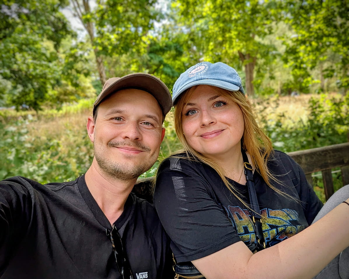 A picture of me and my wife sitting on the grass in Queen&rsquo;s Square, Bristol, UK